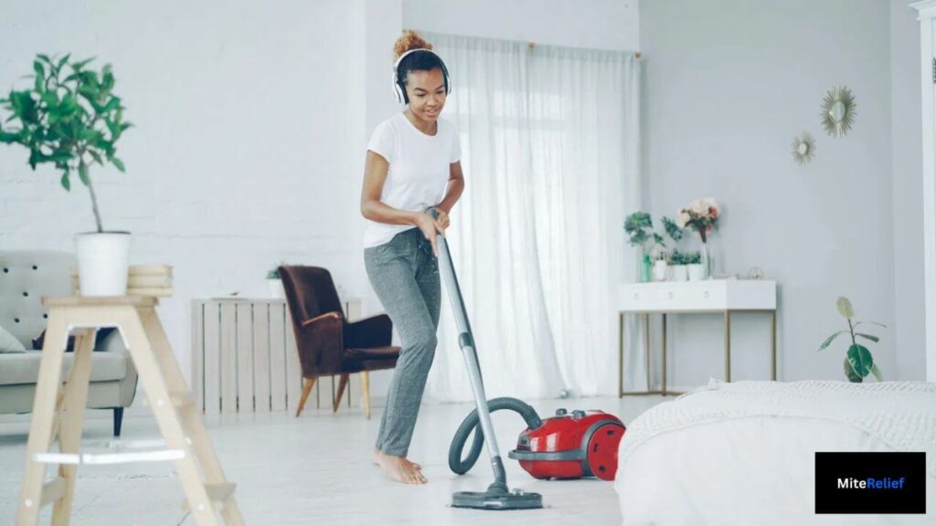 HEPA vacuum cleaning bedroom floor to reduce dust mite allergens